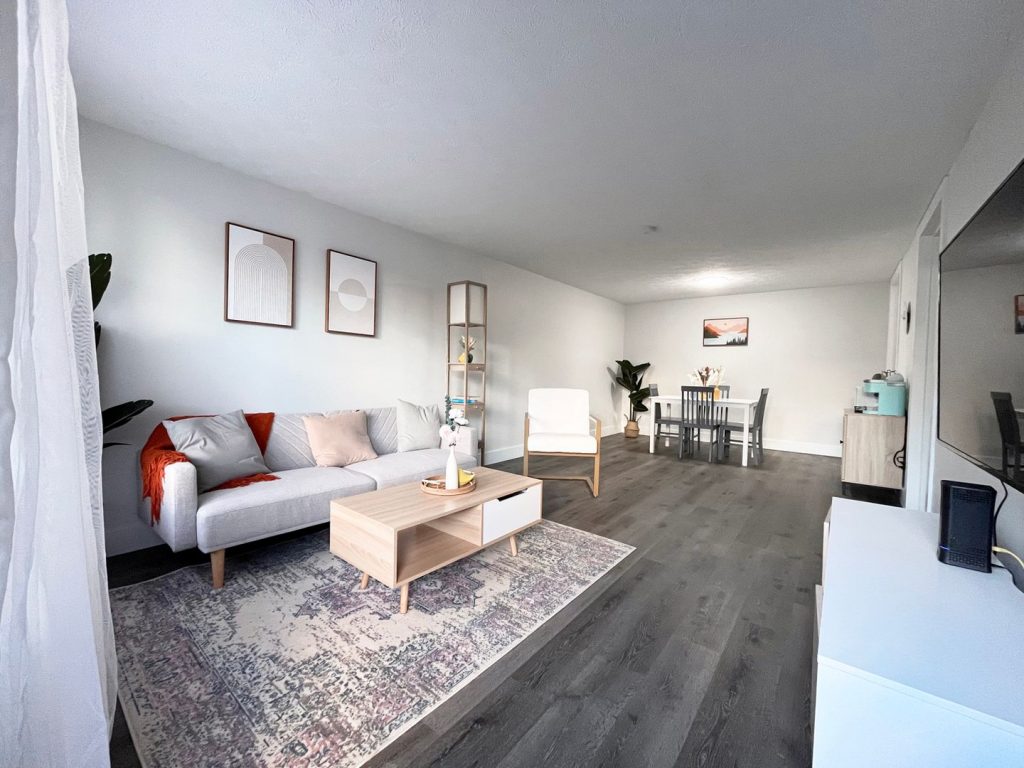 Woodgate Apartments, Johnstown, OH: renovated living room with vinyl plank flooring