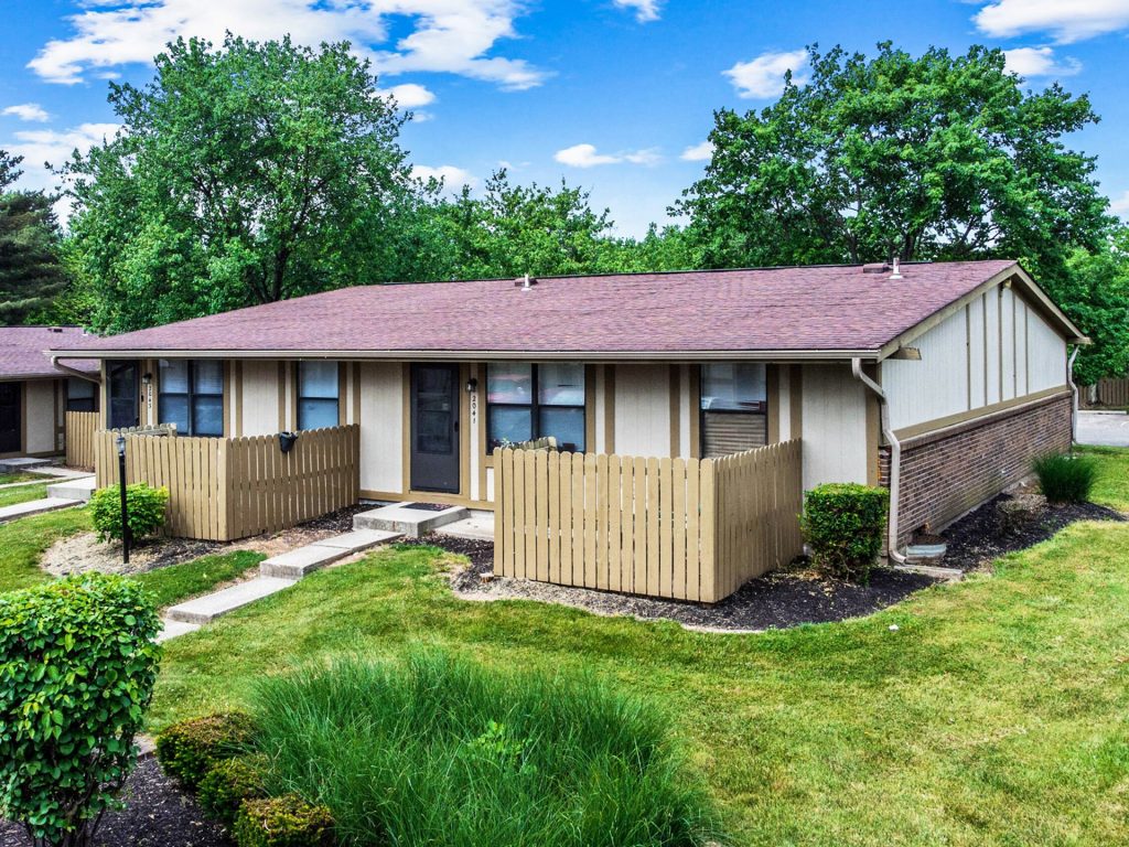 Woodgate Apartments, Johnstown, OH: single-story apartment buildings with fenced patios and lawn
