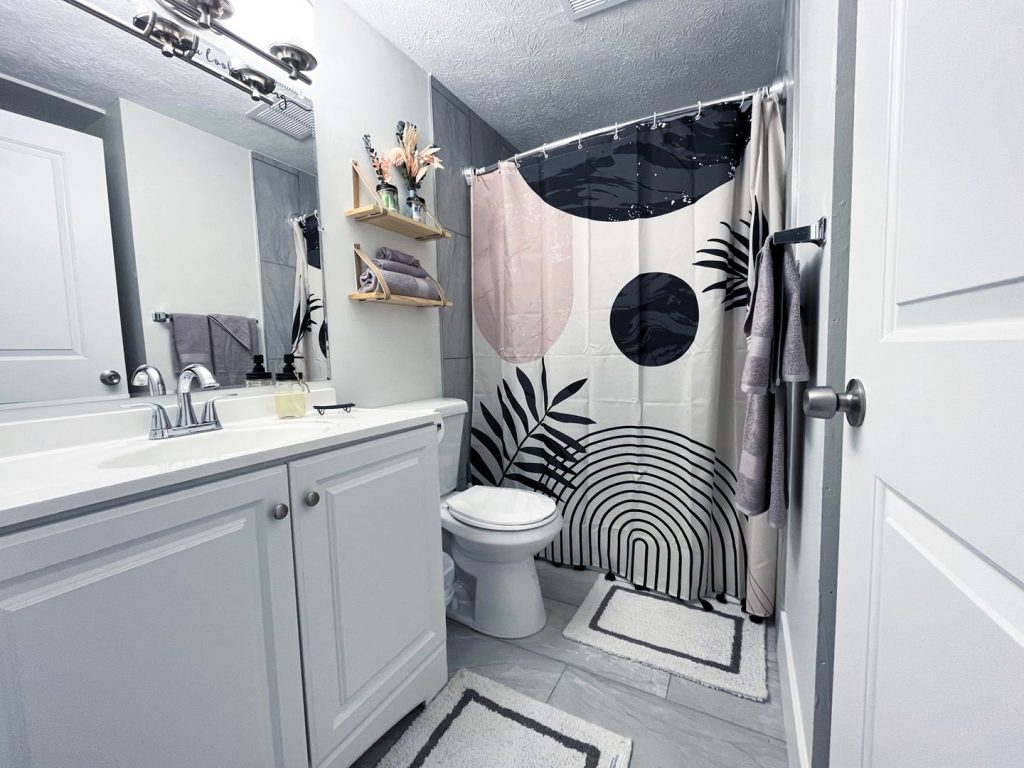 Woodgate Apartments, Johnstown, OH: updated bathroom with white vanity
