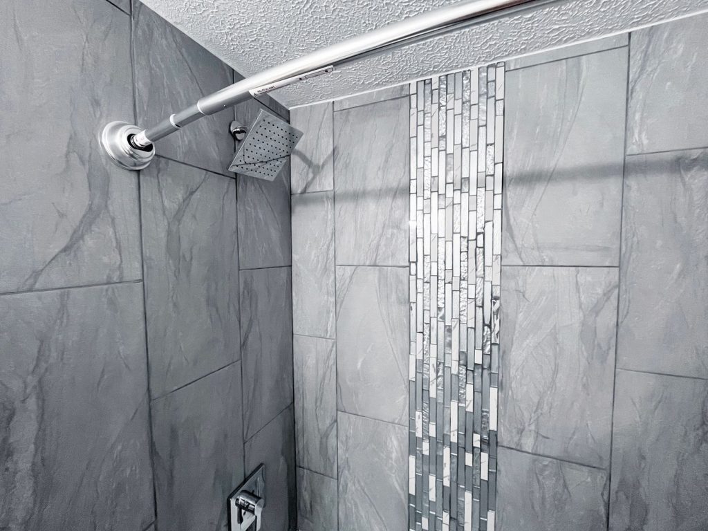 Woodgate Apartments, Johnstown, OH: tiled shower with mosaic accent strip